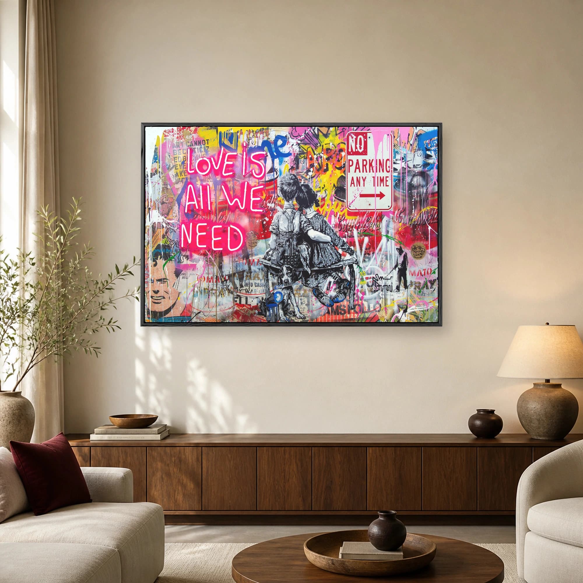Street art canvas print featuring monochrome children and a dog sitting before a graffiti wall with a glowing pink neon sign reading Love Is All We Need.