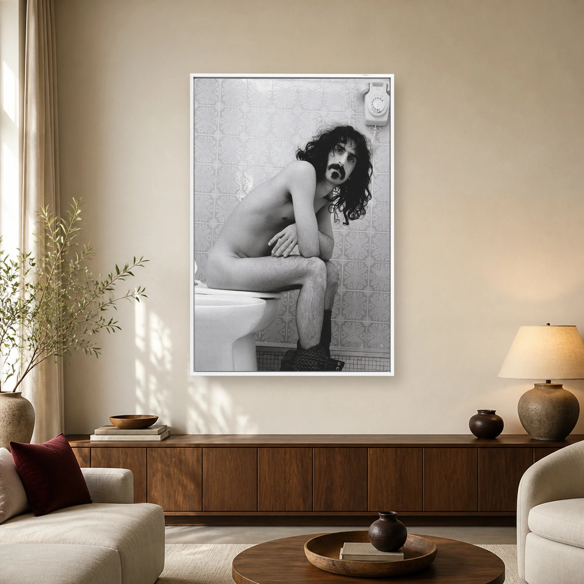 Black and white fine art print featuring musician Frank Zappa seated humorously on a toilet in a tiled bathroom.