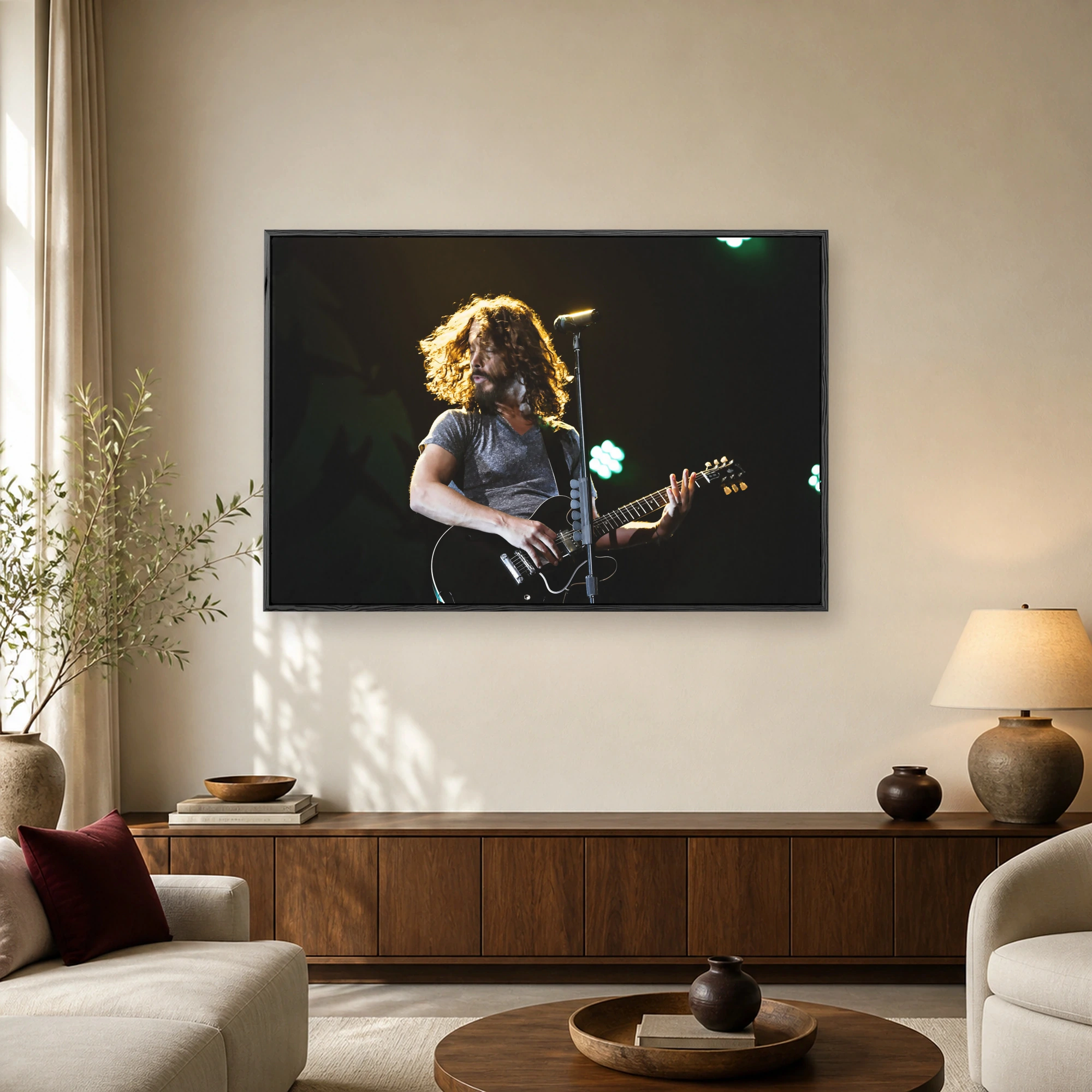 A rock musician with long curly hair playing a black electric guitar on stage under dramatic golden and green concert lighting.
