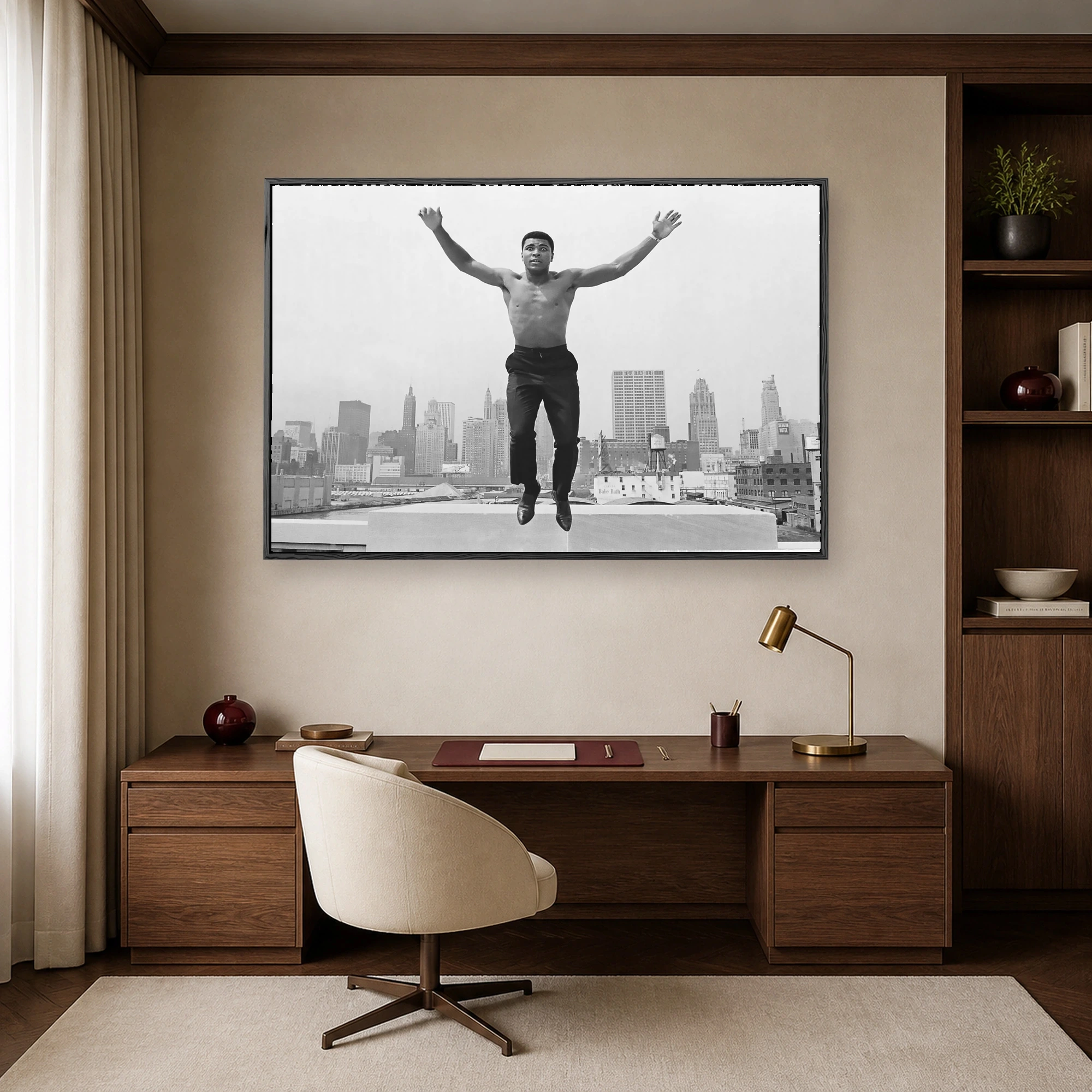 Black and white photograph of a shirtless Muhammad Ali leaping mid-air with outstretched arms above the Chicago skyline