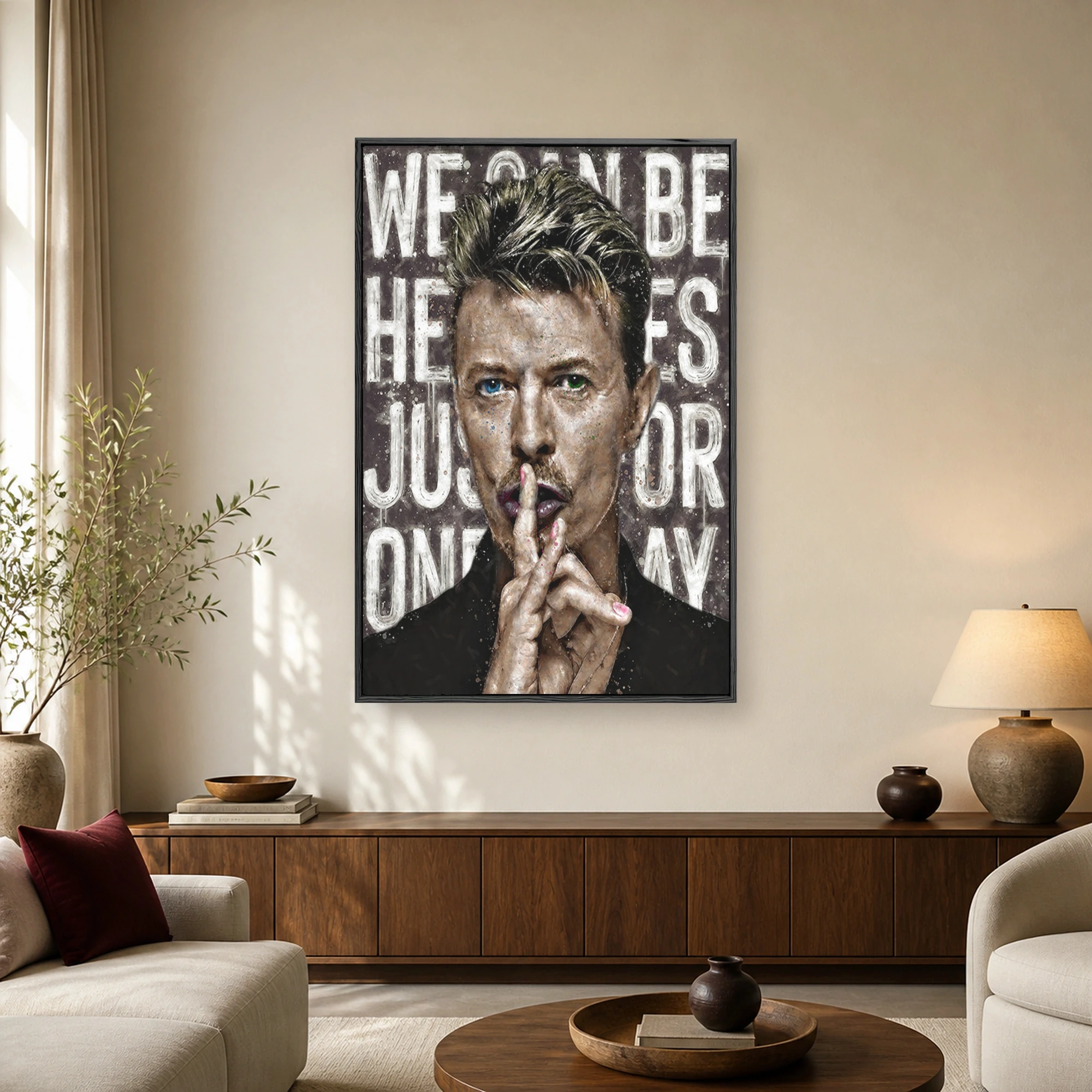 A striking portrait of David Bowie with heterochromia holding a finger to his lips against a textured background with bold white typography.