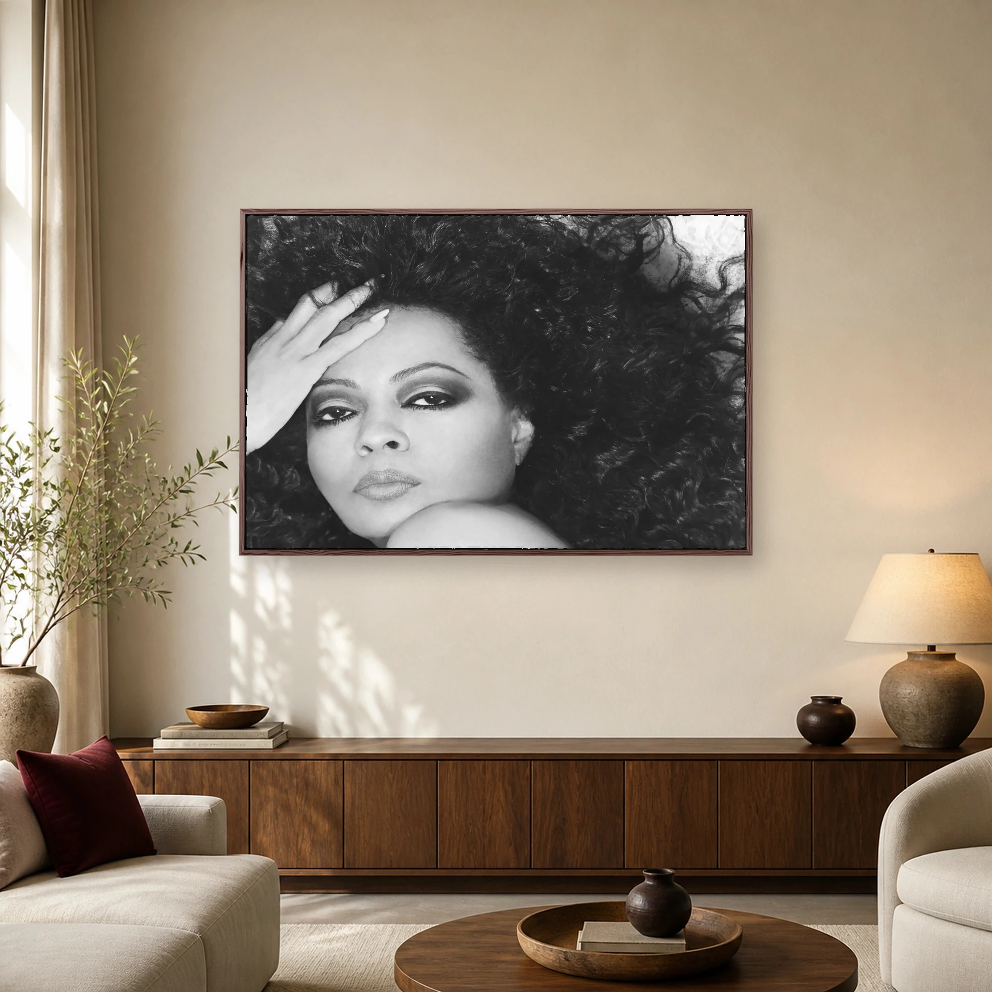 Black and white portrait of Diana Ross with voluminous curly hair and a hand resting on her forehead, exuding timeless glamour.